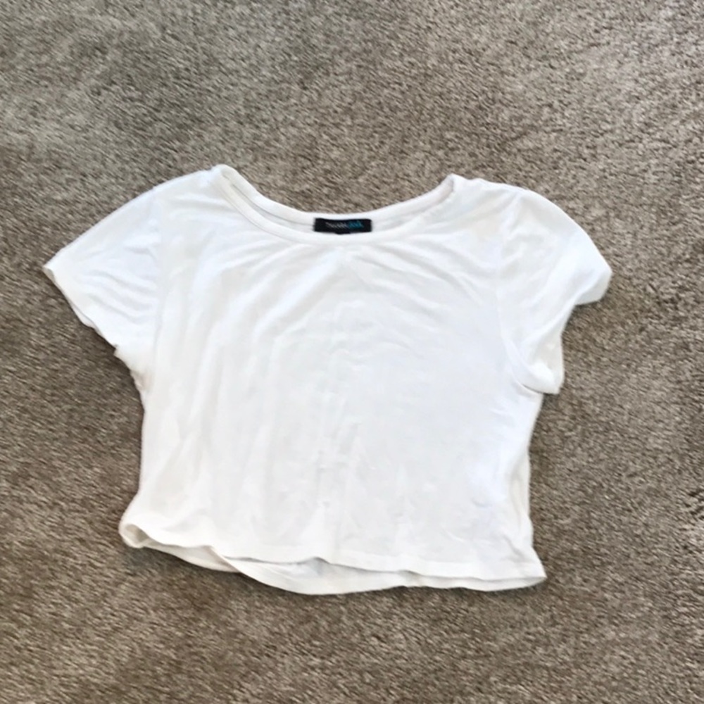 A cream white Takara girls crop top.